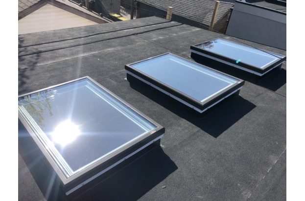 Three glass unit skylights on a residential roof