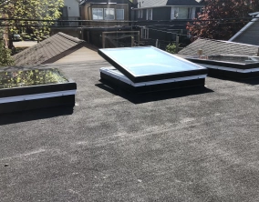 Three glass unit skylights on a residential roof