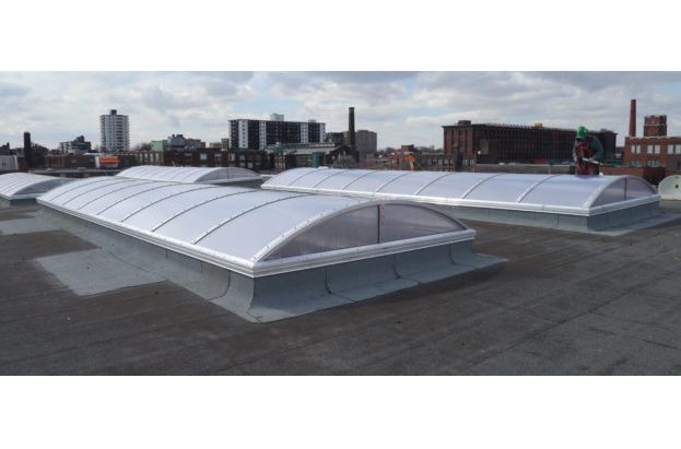 Vertical End dome end skylights on a flat roof with a city view