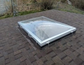 Removable Skylight with Clear Acrylic Domes on a Sloped Shingle Roof