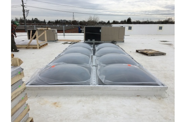 Bronze Acrylic Dome Butted Skylights on a White Reflective Roof