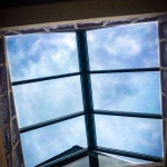 glass pyramid skylight with matte black framing clear glass vertical ends